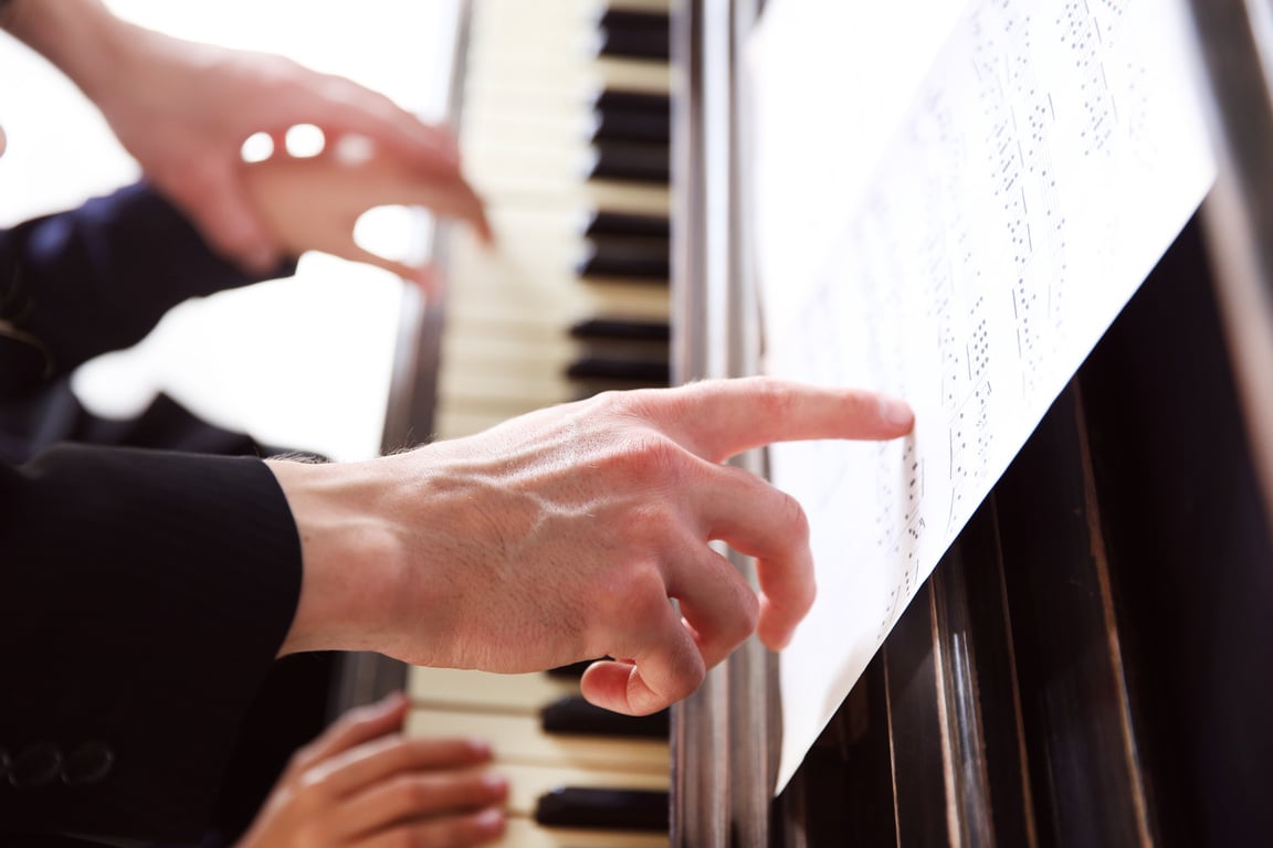 Music Teacher and Student Playing Piano